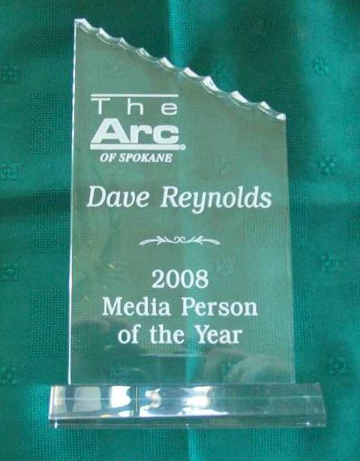 clear acrilic plaque with stand, with "The Arc of Spokane,  Dave Reynolds, 2008 Media Person of the Year" etched in white